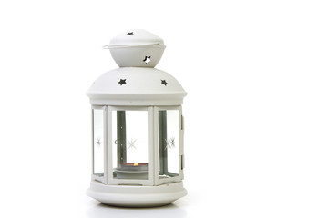 white lighthouse with a burning candle inside on a white background - 181494042