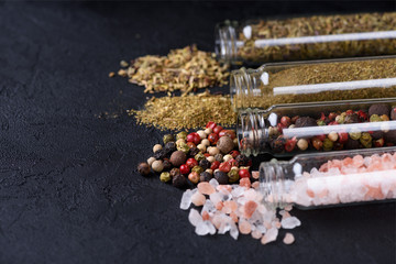 Spices assortment in glass tubes on stone table