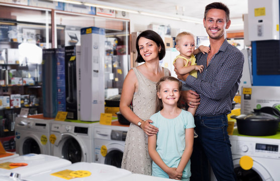Smiling family with children shopping goods