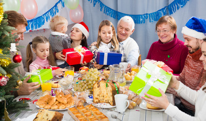 Large family handing gifts to each other