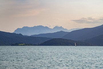 Sailing on Walchensee in Bavaria, Germany with beautiful view towards Zugspitze at dusk