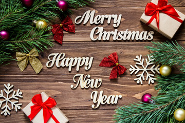 Merry Christmas and Happy New Year. Gifts and christmas tinsel on the wooden background