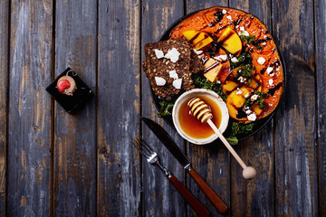 Baked Pumpkin with kale, persimmon and feta