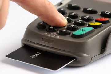 POS terminal with credit card. Man entering security code in payment terminal device with chip card inserted