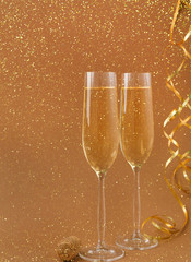 Champagne flutes on golden holiday background
