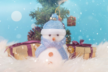 Happy snowman standing in blue winter christmas snow background. Merry christmas and happy new year greeting card with copy-space. Christmas celebration holiday background