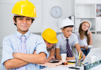 Teenager boy engineer and children with plan