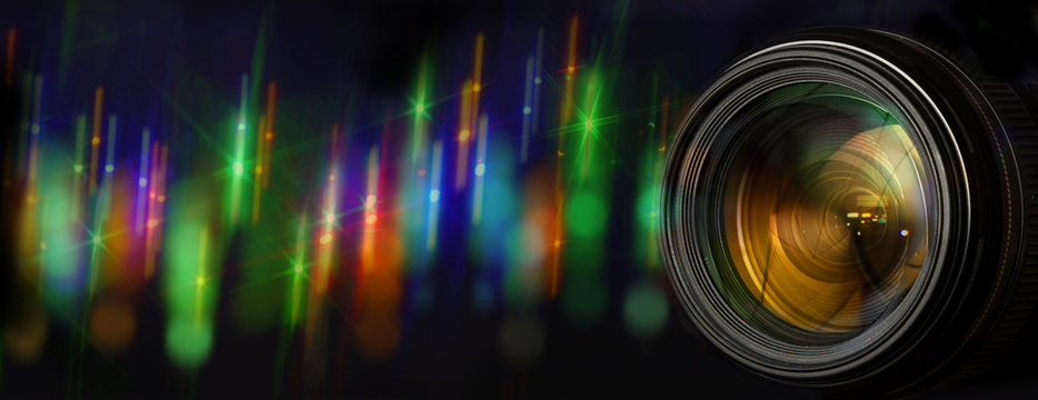Photo lens with original background with blurred flares of street lights at night