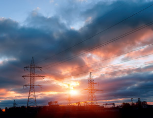 Silhouette image of the high voltage electricity pole with sky on sunset time
