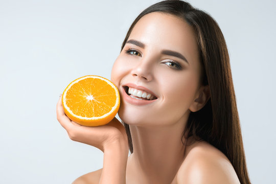 Beautiful Woman's Face With Juicy Orange