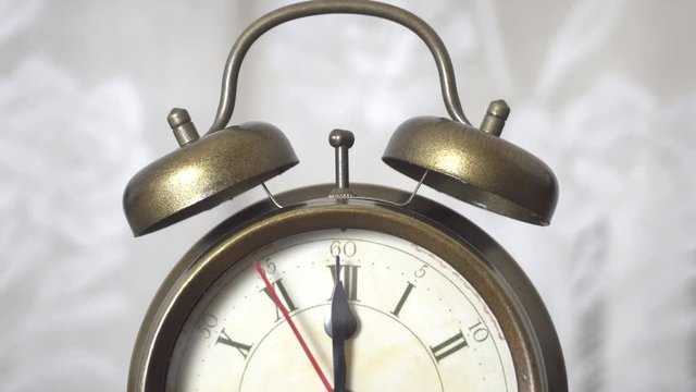 4K Alarm clock ticking towards 12 o'clock. Midnight or noon