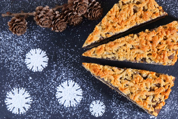 German poppyseed cake on christmas background. New Year sweets. Christmas New Year background.