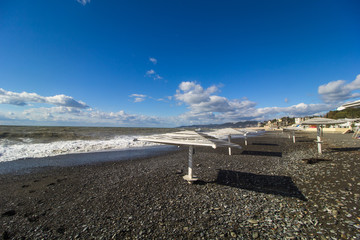Fototapeta premium empty beach of the Black sea with sun loungers on a sunny day