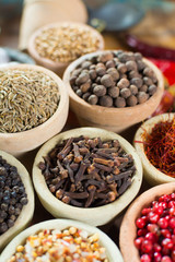 Variety of different asian and middle east spices, colorful assortment, on old wooden table