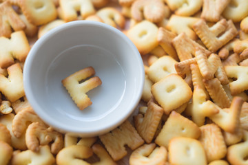 Alphabet biscuit in ceramic cups letters F