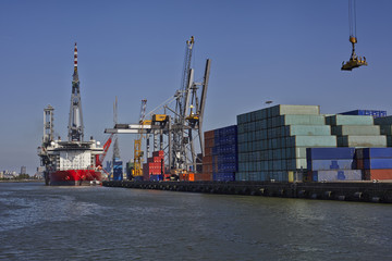 Large harbor cranes loading a large container ship