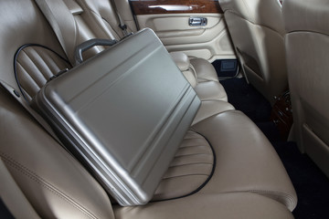 Luxury metal briefcase on the car back seat