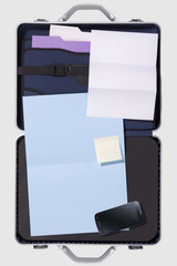 Businessman's briefcasewith smartphone, financial report on a white background