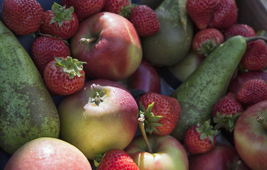 Background of ripe apples and strawberries