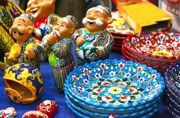 Ceramic plates and  figures of Uzbek men n in traditional clothing - robe and a skullcap, painted...
