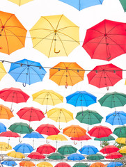 Fototapeta na wymiar Street with umbrellas in the sky