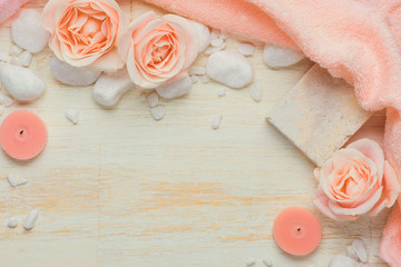 Spa settings with roses. Various items used in spa treatments on white wooden background.