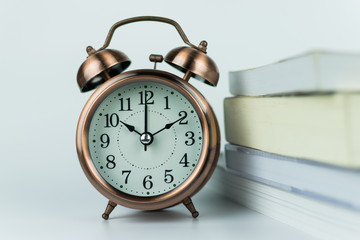 alarm clock and book