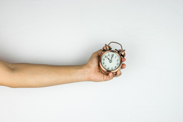 Hand holding alarm clock