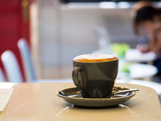 Latte Art, coffee isolated in black cup at coffee shop.