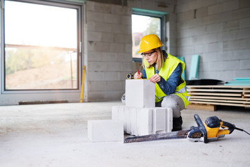 Young woman worker on the building site.