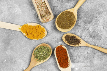Various spices on a gray background. Top view. Food background
