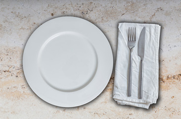 Empty plate and cutlery on marble
