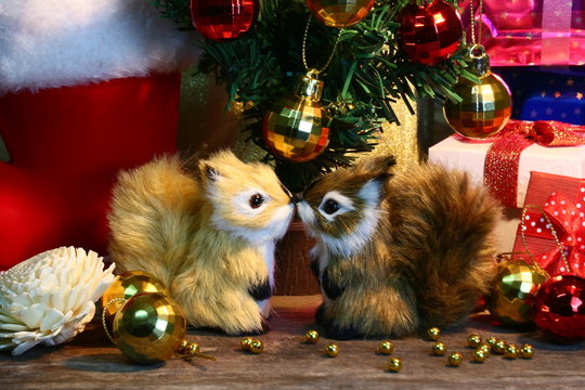 Two Squirrels and gift decorate under christmas tree for celebration christmas party.