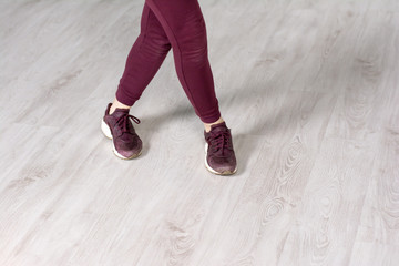 Female hip-hop dancer, cropped image. Casual dancer woman in sport clothing practicing dance element in studio.