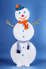 Beautiful funny Snowman in cap and scarf