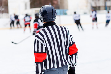 Fototapeta premium Referee on rink on ice hockey game.