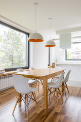 Wooden table and white chairs