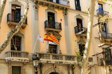 Fototapeta na wymiar Three Flags on Old Barcelona Apartment Building