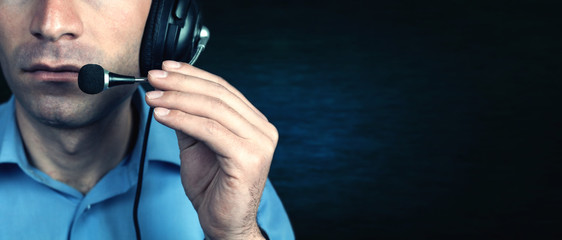 Businessman with headset on a blue background.