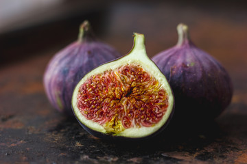 Beautiful and fresh figs on rusty surface. Half of fig.