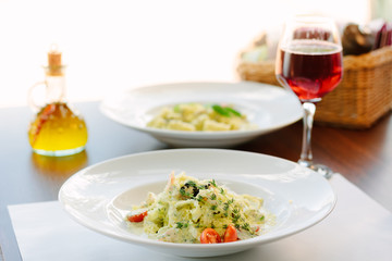 Italian food - fettuccine pasta with spinach and seafood.