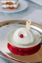Beautiful and delicious panna cotta on red plate.
