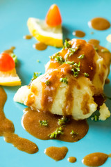 The mashed potatoes are on a blue plate.