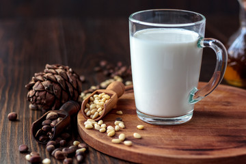 Glass filled by cedar or pine milk with nuts.