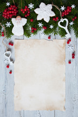 Christmas wood background with spruce branches, gingerbread, ornaments, berries