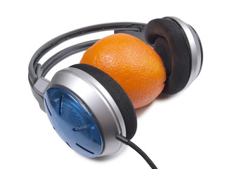 Music headphones and orange on white background