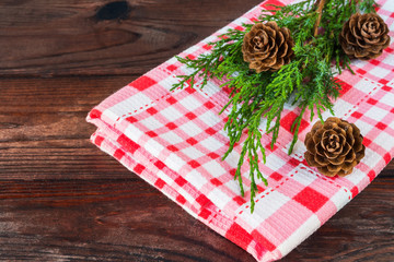 Christmas decorations frame background of fir branches, sosonic cones and cranberries on a black background with copy space forks from above