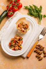 salmon with fresh tomatoes  zucchinis and almonds
