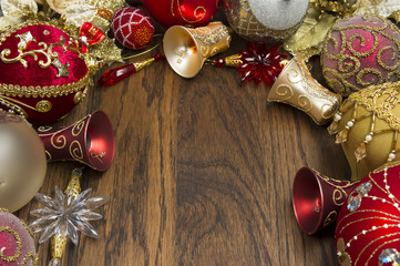 Christmas decorations ornament, new year toys of red and gold colors on wooden background, xmas winter holidays and celebrations concept, selective focus 