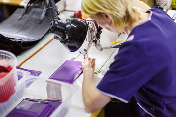 woman stitching a purse
